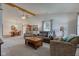 Spacious living room with ample seating, large windows, and a view into the dining area at 7911 Bentley Commons Dr, Indianapolis, IN 46259