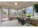 Relaxing sunroom featuring brick accents, ample windows, and indoor plants at 7911 Bentley Commons Dr, Indianapolis, IN 46259