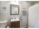 Bathroom features gray walls, framed mirror, vanity, shower, and toilet at 8025 Meadow Ln, Indianapolis, IN 46227