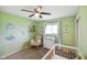 Bright Bedroom featuring a rocking chair, crib, dresser, and nautical themed wall decor at 8025 Meadow Ln, Indianapolis, IN 46227