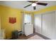 Bedroom featuring yellow walls, ceiling fan, closet, and white dresser at 8025 Meadow Ln, Indianapolis, IN 46227