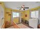 Bedroom with yellow walls, ceiling fan, and a white dresser at 8025 Meadow Ln, Indianapolis, IN 46227