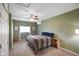 Spacious bedroom with green walls, ceiling fan, carpeted floors, and natural lighting at 8025 Meadow Ln, Indianapolis, IN 46227