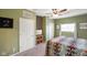 Spacious bedroom featuring carpeted floors, ceiling fan, and natural lighting at 8025 Meadow Ln, Indianapolis, IN 46227