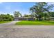 Charming single-story home featuring a lush green lawn, attached garage, and a welcoming front porch at 8025 Meadow Ln, Indianapolis, IN 46227