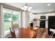 Bright eat-in kitchen featuring white cabinets, black appliances, and a window view at 8025 Meadow Ln, Indianapolis, IN 46227