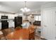 Open-concept kitchen and living area with white cabinets, modern appliances, and an island countertop at 8025 Meadow Ln, Indianapolis, IN 46227