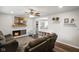 Inviting living room featuring a fireplace, shiplap accent wall, and access to dining and kitchen at 8025 Meadow Ln, Indianapolis, IN 46227