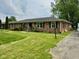 Charming brick ranch with well-maintained lawn and classic black shutters at 8061 Sycamore Springs Trl, Indianapolis, IN 46239