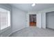 Bedroom featuring neutral paint, carpet, and window with views of the entryway and staircase at 8178 Foxchase Cir, Indianapolis, IN 46256