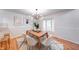 Sun-filled dining room featuring modern lighting, wood floors, and a bay window for natural light at 8178 Foxchase Cir, Indianapolis, IN 46256
