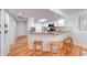 Cozy kitchen featuring wood floors, granite countertops, white cabinets and a bar with seating at 8178 Foxchase Cir, Indianapolis, IN 46256
