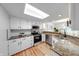 A bright kitchen with stainless appliances, wood floors, granite countertops and white cabinets at 8178 Foxchase Cir, Indianapolis, IN 46256