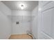 A simple laundry room with tile floor, utility connections, and open shelving at 8178 Foxchase Cir, Indianapolis, IN 46256