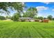 Large backyard with lots of grass features a storage shed and privacy fence at 8760 Big Bend Rd, Martinsville, IN 46151