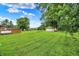 Expansive backyard features green grass, a shed, and mature trees at 8760 Big Bend Rd, Martinsville, IN 46151