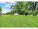 Lush backyard with a storage shed features plenty of space and mature trees at 8760 Big Bend Rd, Martinsville, IN 46151