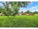 Well-maintained backyard featuring a lush lawn, mature trees, and a fenced perimeter at 8760 Big Bend Rd, Martinsville, IN 46151