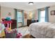 Bright bedroom featuring natural light, hardwood floors, area rug, and blue curtains at 8760 Big Bend Rd, Martinsville, IN 46151