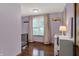 Cozy purple Bedroom room featuring hardwood floors, a window, and a black crib at 8760 Big Bend Rd, Martinsville, IN 46151