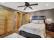 Comfortable bedroom featuring a ceiling fan, hardwood floors, and a bright ensuite bathroom at 8760 Big Bend Rd, Martinsville, IN 46151