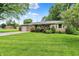 Beautiful one-story home with a lush green lawn, mature trees, and a welcoming front porch at 8760 Big Bend Rd, Martinsville, IN 46151