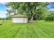 Backyard with a storage shed, lots of trees, and green grass at 8760 Big Bend Rd, Martinsville, IN 46151