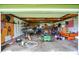 Organized garage space featuring tools, lawn equipment, storage shelves, and an American flag at 8760 Big Bend Rd, Martinsville, IN 46151