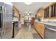 Well-lit kitchen with stainless steel appliances, wood cabinetry, and a seamless flow into the dining area at 8760 Big Bend Rd, Martinsville, IN 46151
