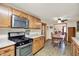 Modern kitchen featuring stainless steel appliances, wood cabinets, and an open view of the dining room at 8760 Big Bend Rd, Martinsville, IN 46151