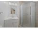 This bathroom features a vanity with white cabinets, a framed mirror, and a shower with a sliding glass door at 904 Dreamy St, Greenwood, IN 46142