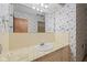 Full bathroom showcasing a vintage, patterned wallpaper and neutral colored fixtures at 904 Dreamy St, Greenwood, IN 46142