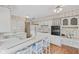 Bright kitchen with white cabinets, a breakfast bar, and modern appliances for functionality and style at 904 Dreamy St, Greenwood, IN 46142