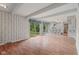 Bright living room featuring hardwood floors, white ceiling beams, and sliding glass doors leading to the backyard at 904 Dreamy St, Greenwood, IN 46142