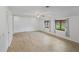 Empty living room with two windows, light colored walls and floors, and a ceiling fan at 904 Dreamy St, Greenwood, IN 46142