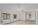 Empty living room with two windows, light colored walls and floors, and a ceiling fan at 904 Dreamy St, Greenwood, IN 46142