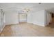 Empty living room featuring light colored walls and floors with a ceiling fan and an open doorway at 904 Dreamy St, Greenwood, IN 46142