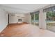 Open living room with a brick fireplace, sliding glass doors to the pool, and bright natural light at 904 Dreamy St, Greenwood, IN 46142