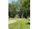 Expansive backyard with lush grass, mature trees, and a shed at 9168 S State Road 9, Flat Rock, IN 47234