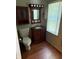 Compact bathroom with wood-style flooring and a classic vanity cabinet at 9168 S State Road 9, Flat Rock, IN 47234