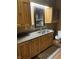 Bathroom featuring wood cabinets, granite counters, mirror and toilet at 9168 S State Road 9, Flat Rock, IN 47234