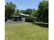 Property with a building with covered porch, lush grass, and established trees at 9168 S State Road 9, Flat Rock, IN 47234