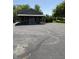 A charming building with a covered porch, a large parking lot, and a blue front door at 9168 S State Road 9, Flat Rock, IN 47234