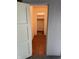 A light-filled hallway with wood flooring offers a welcoming transition to other rooms at 9168 S State Road 9, Flat Rock, IN 47234
