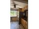 Kitchen with wood cabinets, stainless steel refrigerator, and wood flooring at 9168 S State Road 9, Flat Rock, IN 47234