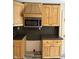 Kitchen featuring wood cabinets and stainless steel microwave at 9168 S State Road 9, Flat Rock, IN 47234