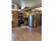 Rustic kitchen featuring wood cabinets, stainless steel appliances, and laminate floors at 9168 S State Road 9, Flat Rock, IN 47234