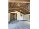 Living room featuring wood beams, wood doors, carpet, and neutral walls at 9168 S State Road 9, Flat Rock, IN 47234