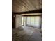 Bright living room featuring a wooden ceiling and beams, accented by sheer curtains at 9168 S State Road 9, Flat Rock, IN 47234