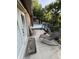 Relaxing patio with lounge chair, dining table and outdoor building. Great for entertaining with fenced stairwell and door at 9168 S State Road 9, Flat Rock, IN 47234